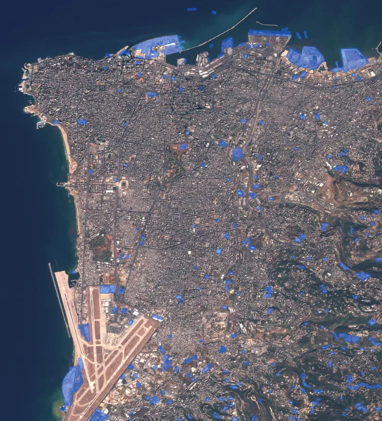 Two-date Sentinel-2 city scene with detected changes highlighted in blue